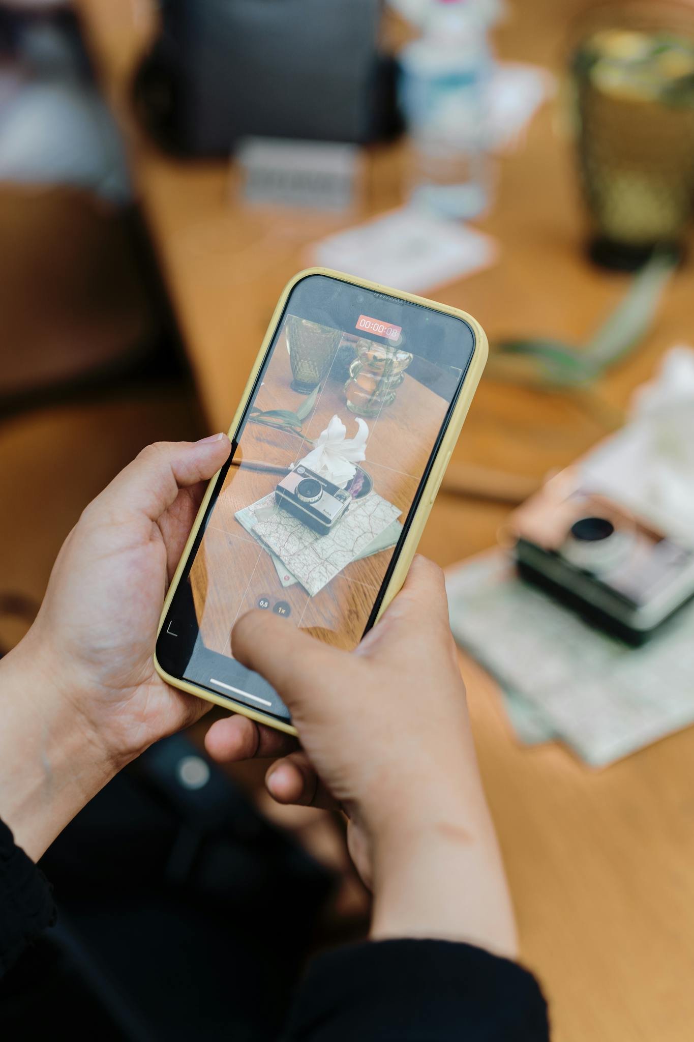 Person capturing image with smartphone indoors, emphasizing modern technology.